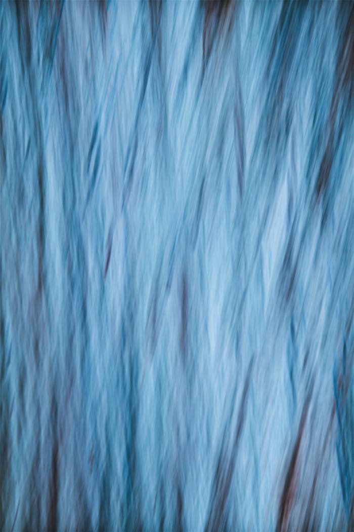 A serene, cool-toned abstract pattern with gentle flowing lines creating a calming blue texture.